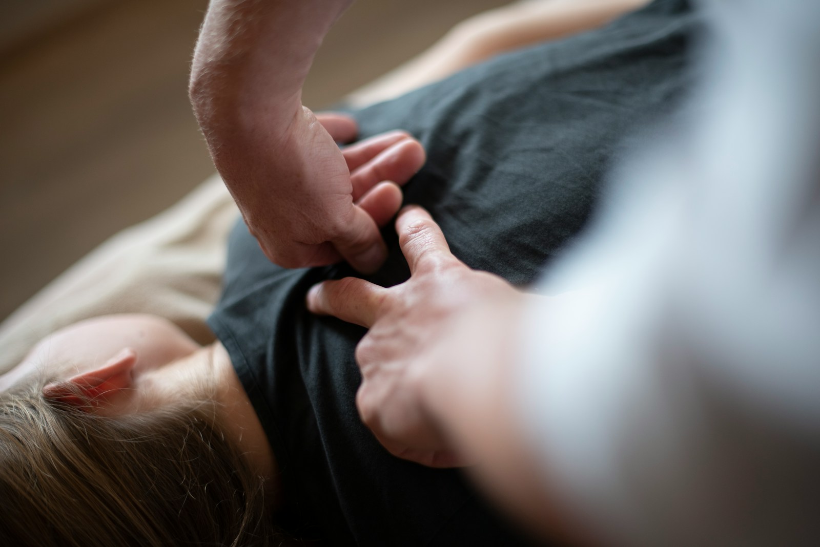 Photo by Edward Muntinga a woman laying on top of a bed holding a mans hand